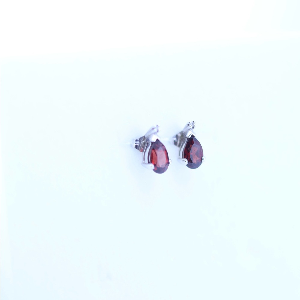 Garnet studs in 14k gold with small diamonds.